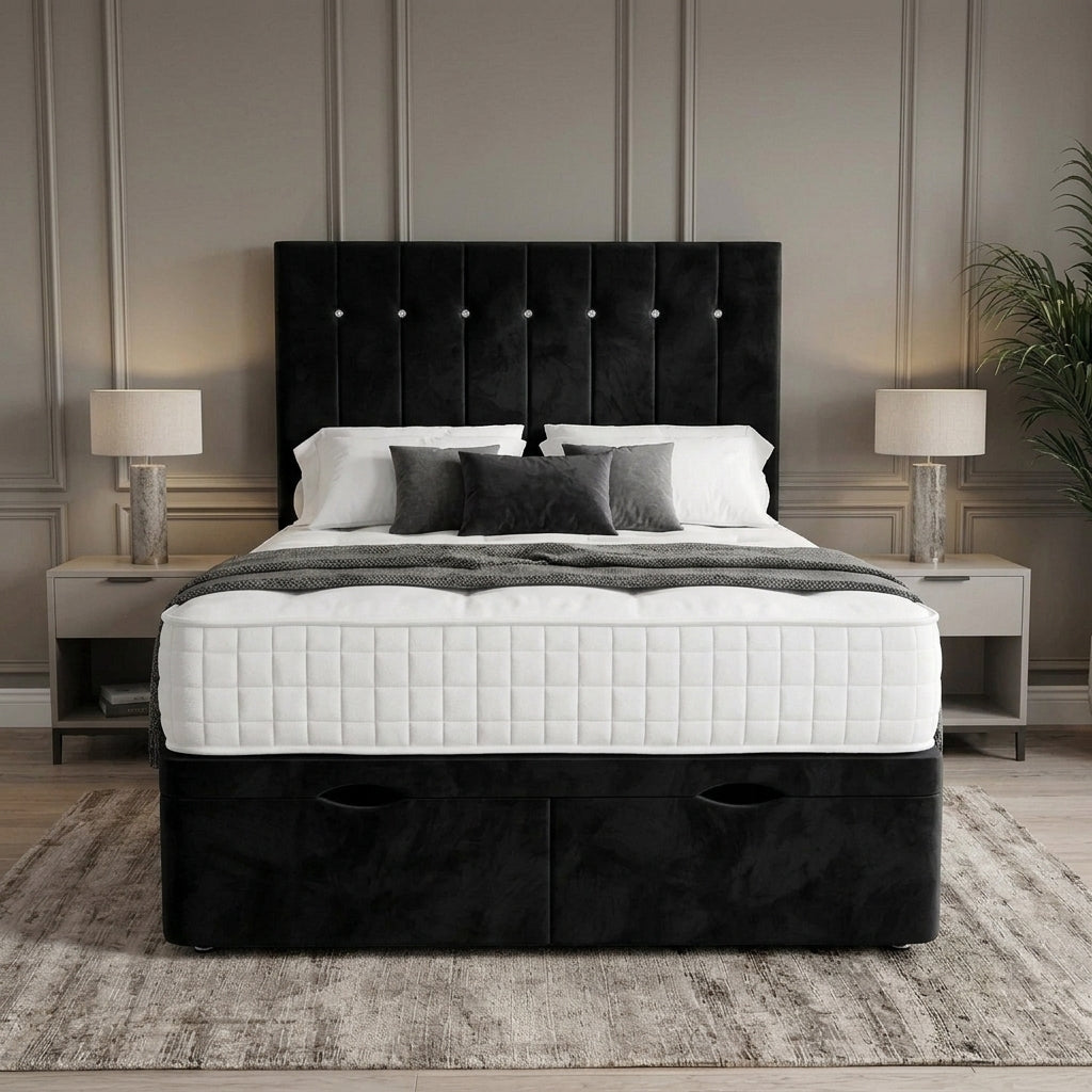 A black tufted velvet bed frame with a high upholstered headboard and storage drawers at the base, shown with white and gray bedding in a styled bedroom setting.
